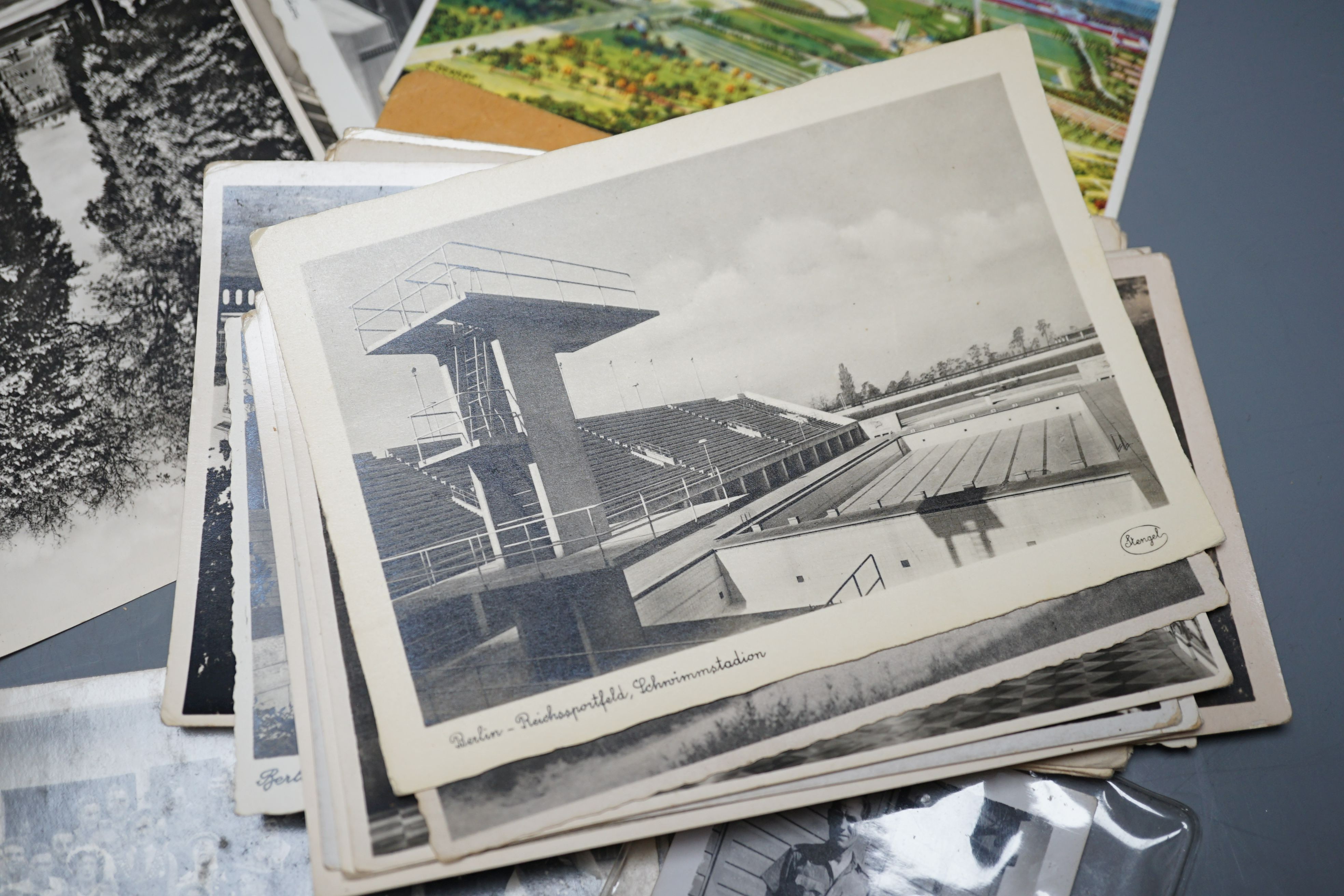 A quantity of mid 20th century German postcards, photos and badges